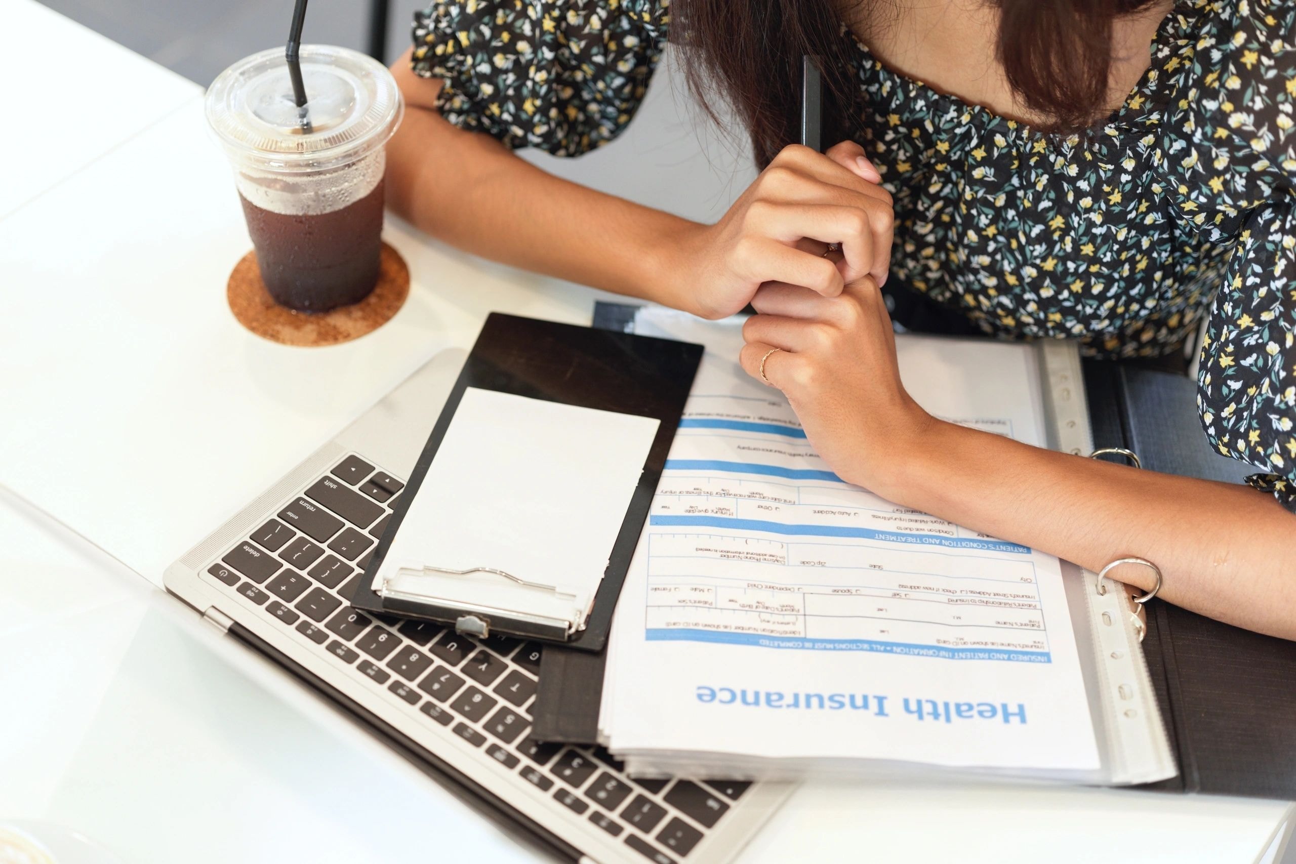 Woman reviewing insurance documents at desk