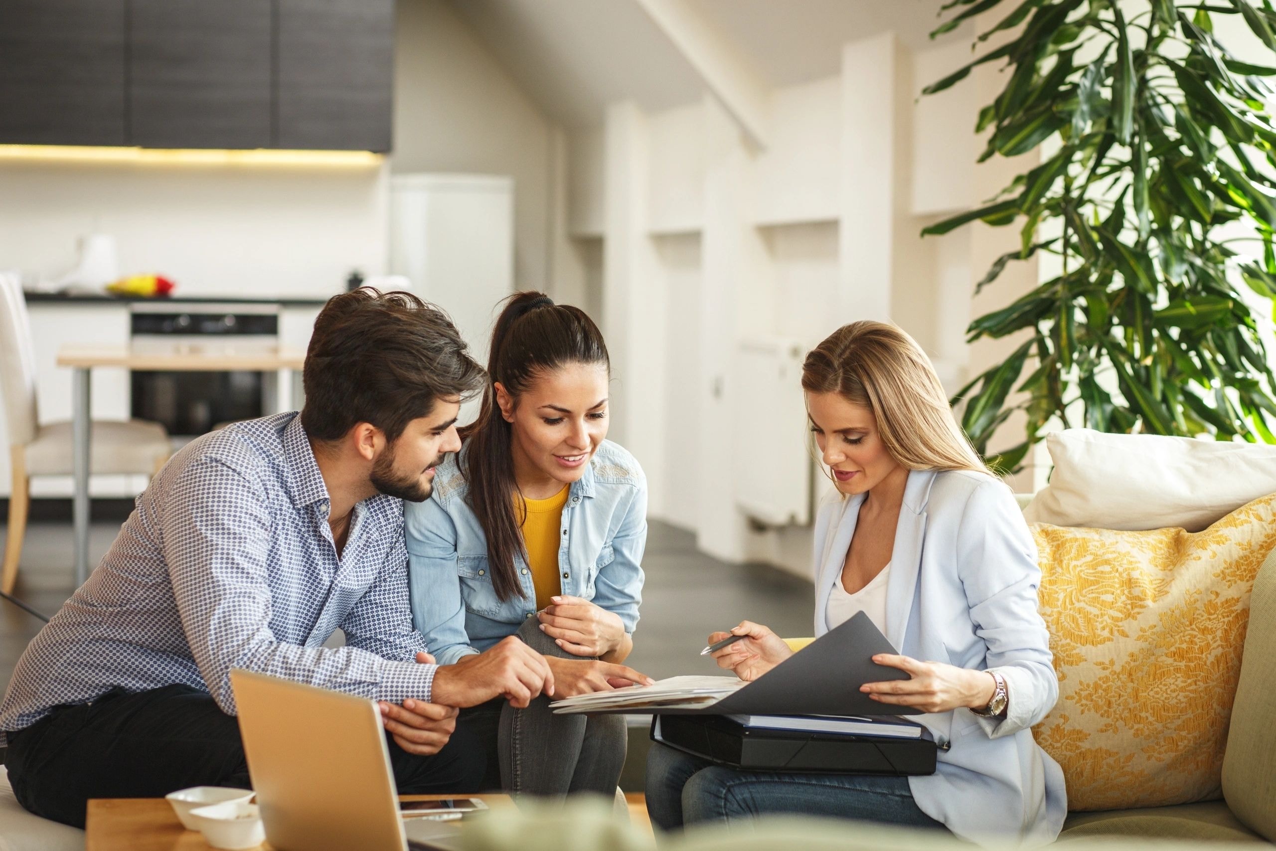 Consultant meeting with young couple reviewing documents