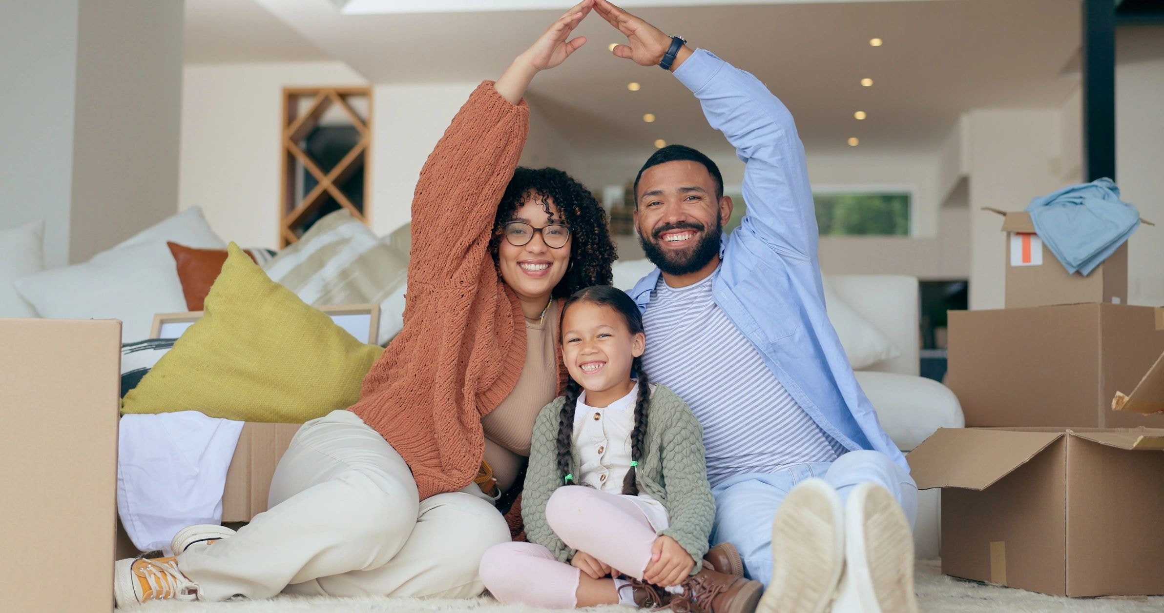 Happy family on couch with moving boxes
